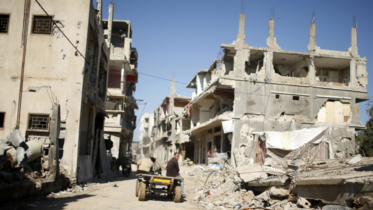 A Palestinian rides a donkey cart past damaged houses in the east of Gaza City A Palestinian rides a donkey cart past houses that witnesses said were damaged or destroyed by Israeli shelling during the most recent conflict between Israel and Hamas, in the east of Gaza City October 21, 2014. The first torrential downpour of an approaching winter has already soaked the Gaza Strip, compounding the misery of thousands of Palestinians who scrambled to patch homes wrecked by the summer war with Israel. While Palestinian officials rejoiced at $5.4 billion pledged at an international aid con