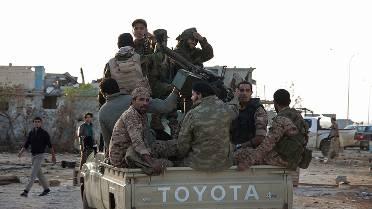 Members of forces loyal to former general Khalifa Haftar ride in a truck in the Benina area, east of Benghazi Members of forces loyal to former general Khalifa Haftar ride in a truck in the Benina area, east of Benghazi October 24, 2014. Violent clashes have taken place over the past few weeks between these forces loyal to Haftar and both the Islamist group, the Shura Council of Libyan Revolutionaries, and an alliance of former anti-Gaddafi rebels Ansar al-Sharia, for control of the airport nearby. The two latter groups have now withdrawn and the area is being controlled by these forces loyal to Haftar. Libya's ar