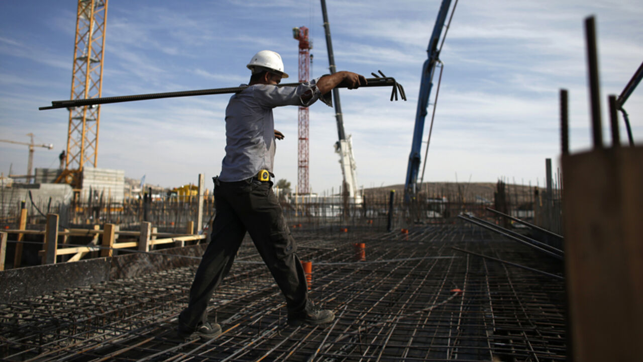A labourer works on an apartment building under construction in a Jewish settlement known to Israelis as Har Homa and to Palestinians as Jabal Abu Ghneim A labourer works on an apartment building under construction in a Jewish settlement known to Israelis as Har Homa and to Palestinians as Jabal Abu Ghneim in an area of the West Bank that Israel captured in a 1967 war and annexed to the city of Jerusalem, October 28, 2014. Israeli Prime Minister Benjamin Netanyahu will expedite planning for some 1,000 settler homes in East Jerusalem, a government official said on Monday, in a bid to placate a restive coalition ally without further aggravating a dispute with