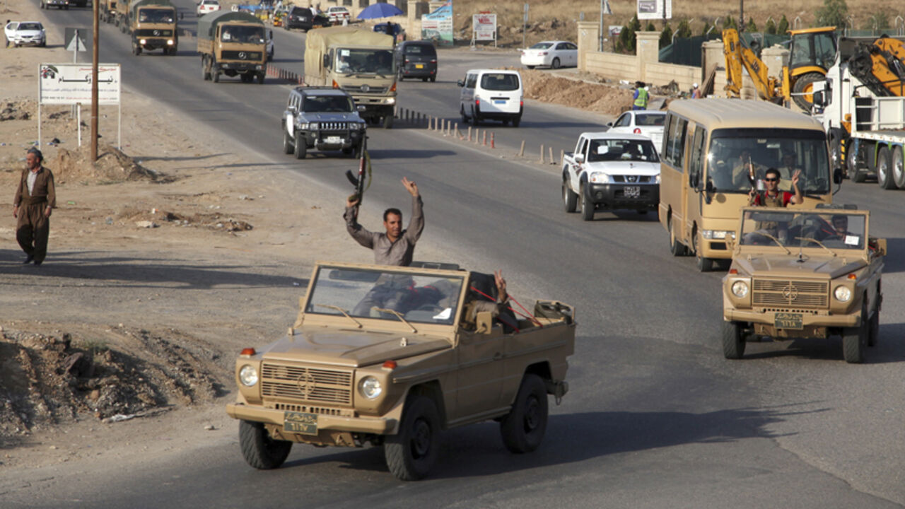 A convoy of Kurdish peshmerga fighters drive through Arbil after leaving a base in northern Iraq A convoy of Kurdish peshmerga fighters drive through Arbil after leaving a base in northern Iraq, on their way to the Syrian town of Kobani ,October 28, 2014. Iraqi peshmerga fighters left Iraq for the besieged Syrian town of Kobani on Tuesday to help fellow Kurds in their battle against Islamic State militants, a senior Kurdish official said. REUTERS/Azad Lashkari (IRAQ - Tags: CIVIL UNREST POLITICS MILITARY CONFLICT) - RTR4BWKZ