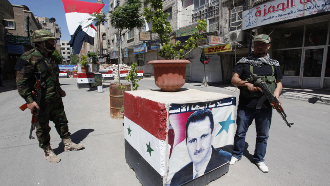 Security personnel loyal to Syria's President Assad stand guard at a checkpoint in Damascus Security personnel loyal to Syria's President Bashar al-Assad stand guard at a checkpoint in Damascus May 27, 2013. Picture taken May 27, 2013. REUTERS/ Alaa Al-Marjani (SYRIA - Tags: CIVIL UNREST POLITICS MILITARY CONFLICT) - RTX104TS