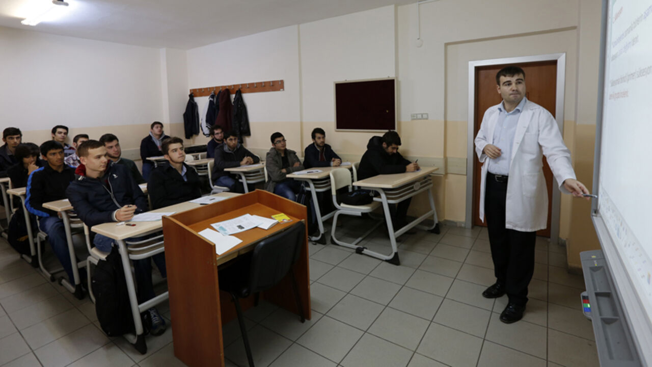 A teacher points to the board as he teaches students during a class at FEM University Preparation School in Uskudar A teacher points to the board as he teaches students during a class at FEM University Preparation School in Uskudar November 27, 2013. At the FEM University Preparation School in Uskudar, a conservative district on the Asian side of Istanbul, young men are quietly receiving specialised coaching in how to pass the exams that give access to the most important jobs in Turkey. To a casual eye, nothing seems remarkable. As in nearly all Turkish schools, a portrait of Ataturk hangs in every classroom. There are n
