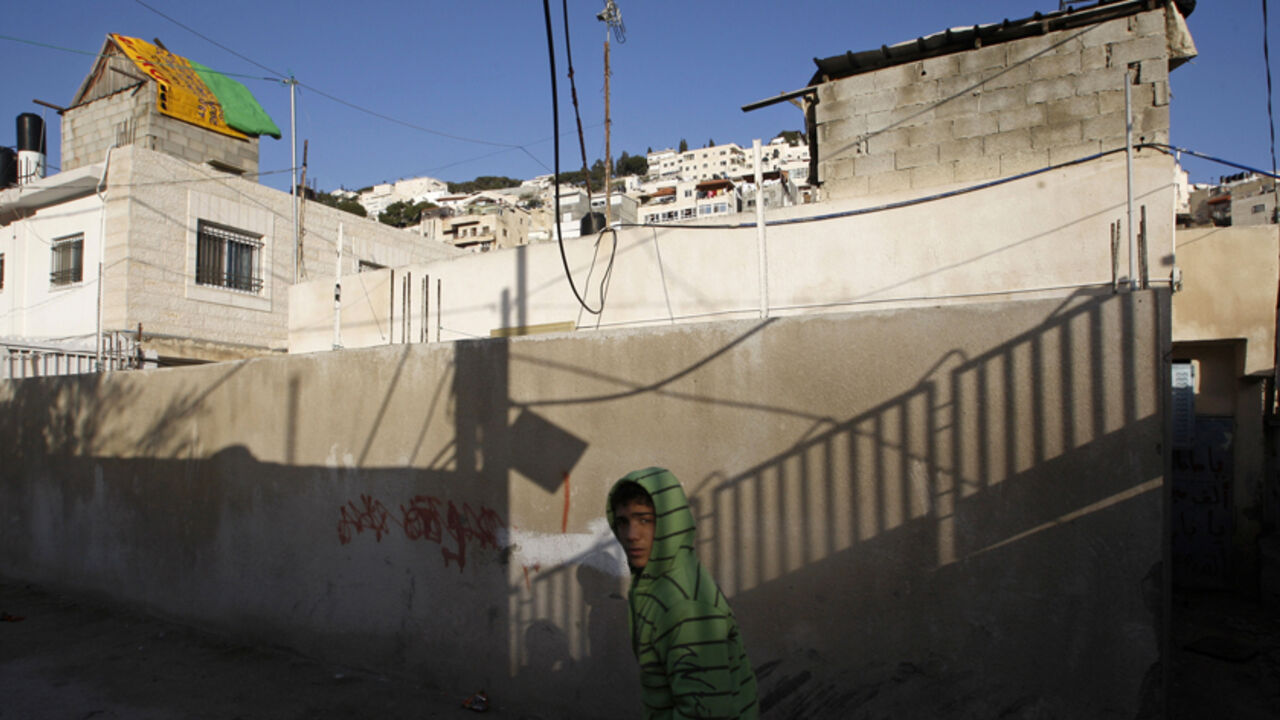 Palestinian walks in neighbourhood of Silwan A Palestinian walks in the neighbourhood of Silwan in Arab East Jerusalem March 4, 2009. U.S. Secretary of State Hillary Clinton criticised Israel on Wednesday over plans to demolish Palestinian homes in Arab East Jerusalem and said Washington would engage Israeli leaders on Jewish settlements. REUTERS/Ronen Zvulun (JERUSALEM) - RTXCCF2