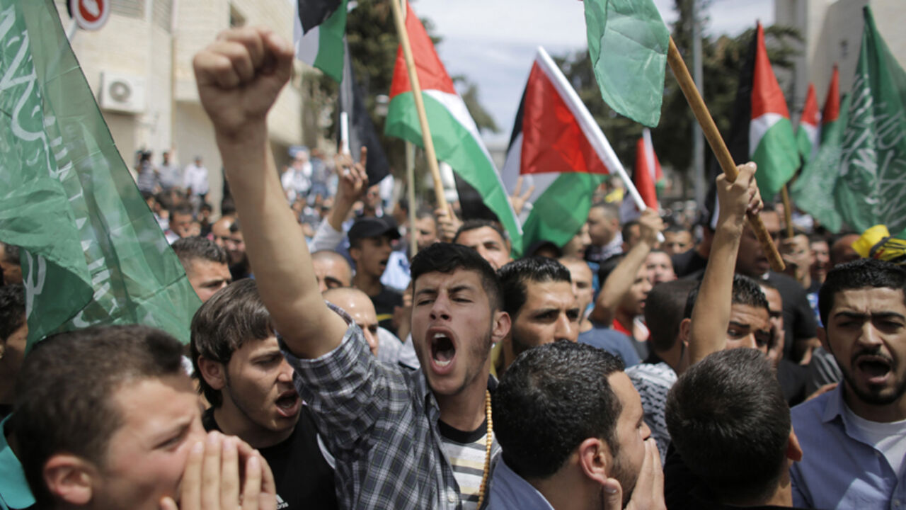 Mourners chant slogans during the funeral of two Palestinians, who were shot dead by Israeli forces on Thursday, in the West Bank city of Ramallah Mourners chant slogans during the funeral of two Palestinians, who were shot dead by Israeli forces on Thursday, in the West Bank city of Ramallah May 16, 2014. Israeli forces shot dead the two Palestinians during a stone-throwing protest on Thursday to mark the "Nakba", or "catastrophe", as Palestinians term their displacement when Israel was founded. REUTERS/Ammar Awad (WEST BANK - Tags: POLITICS) - RTR3PFK8