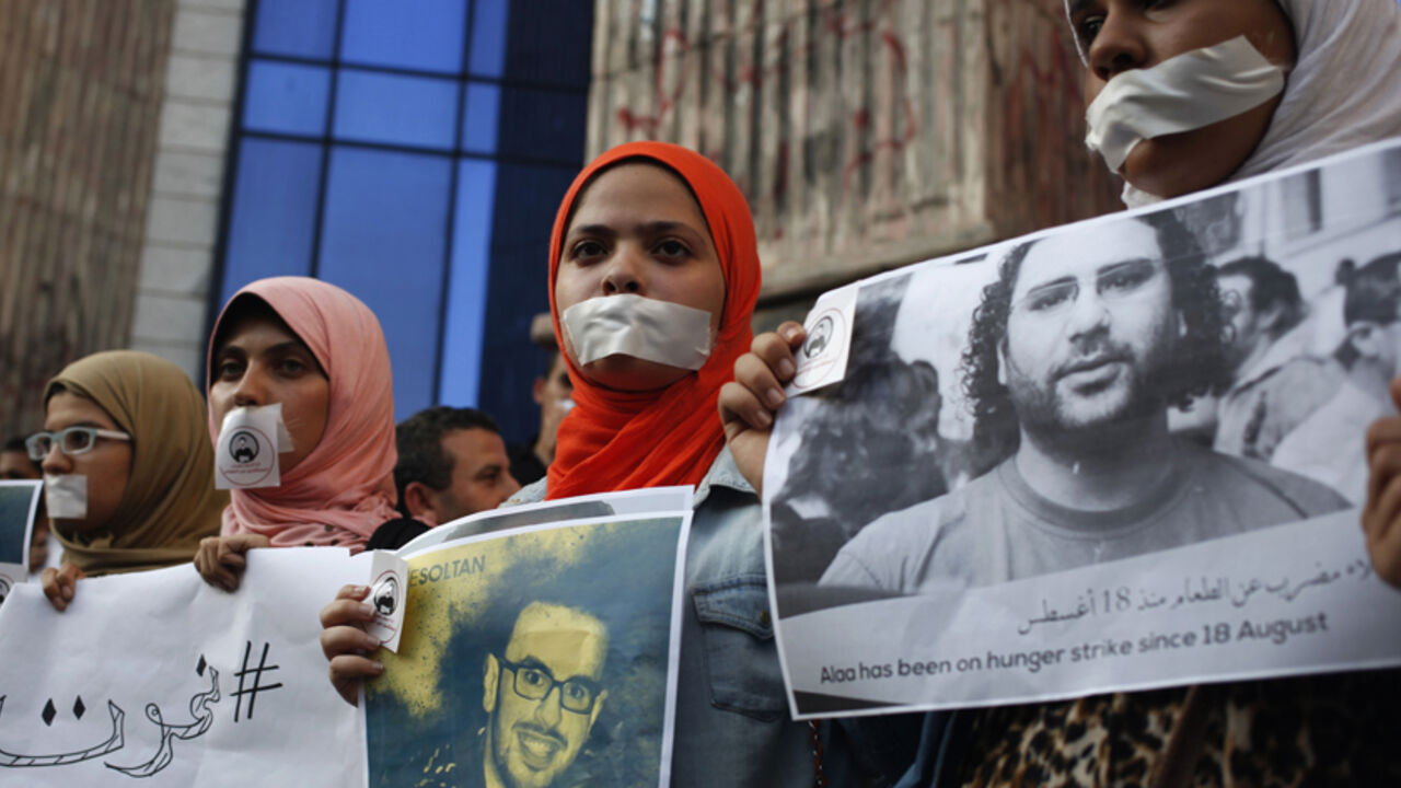Protesters hold pictures during a protest in support of imprisoned activists who are in a hunger strike at prison, in front of the Press Syndicate, in Cairo Protesters hold pictures during a protest in support of imprisoned activists who are in a hunger strike at prison, in front of the Press Syndicate, in Cairo August 25, 2014. REUTERS/Asmaa Waguih (EGYPT - Tags: POLITICS CIVIL UNREST MEDIA) - RTR43OK4