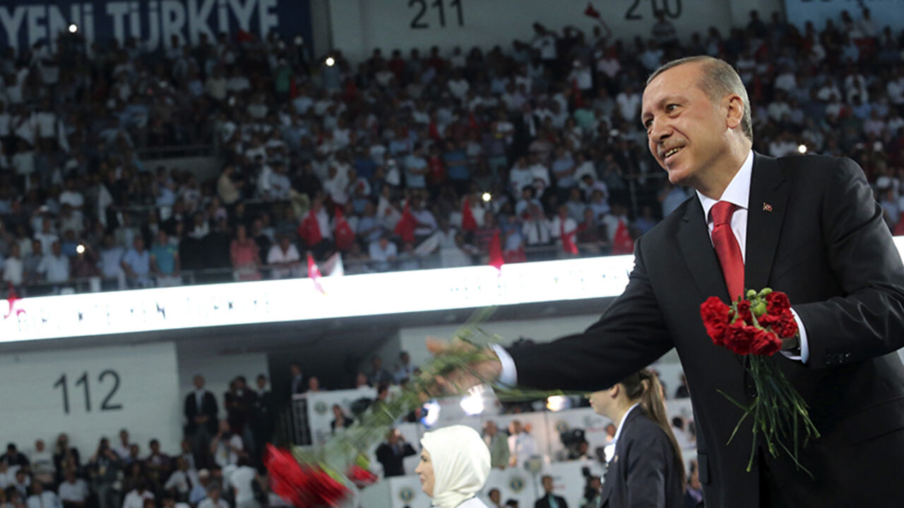 Turkey's PM Erdogan throws flowers to his supporters upon arriving at the Extraordinary Congress of AKP in Ankara Turkey's Prime Minister Tayyip Erdogan throws flowers to his supporters upon arriving at the Extraordinary Congress of the ruling AK Party (AKP) to choose a new leader of the party, ahead of Erdogan's inauguration as president, in Ankara August 27, 2014. Turkish president-elect Erdogan said on Wednesday he would ask incoming prime minister Ahmet Davutoglu to form a new government on Thursday, and a new cabinet of ministers would be announced the following day. REUTERS/Rasit Aydogan/Pool (TURKEY - Tags: P