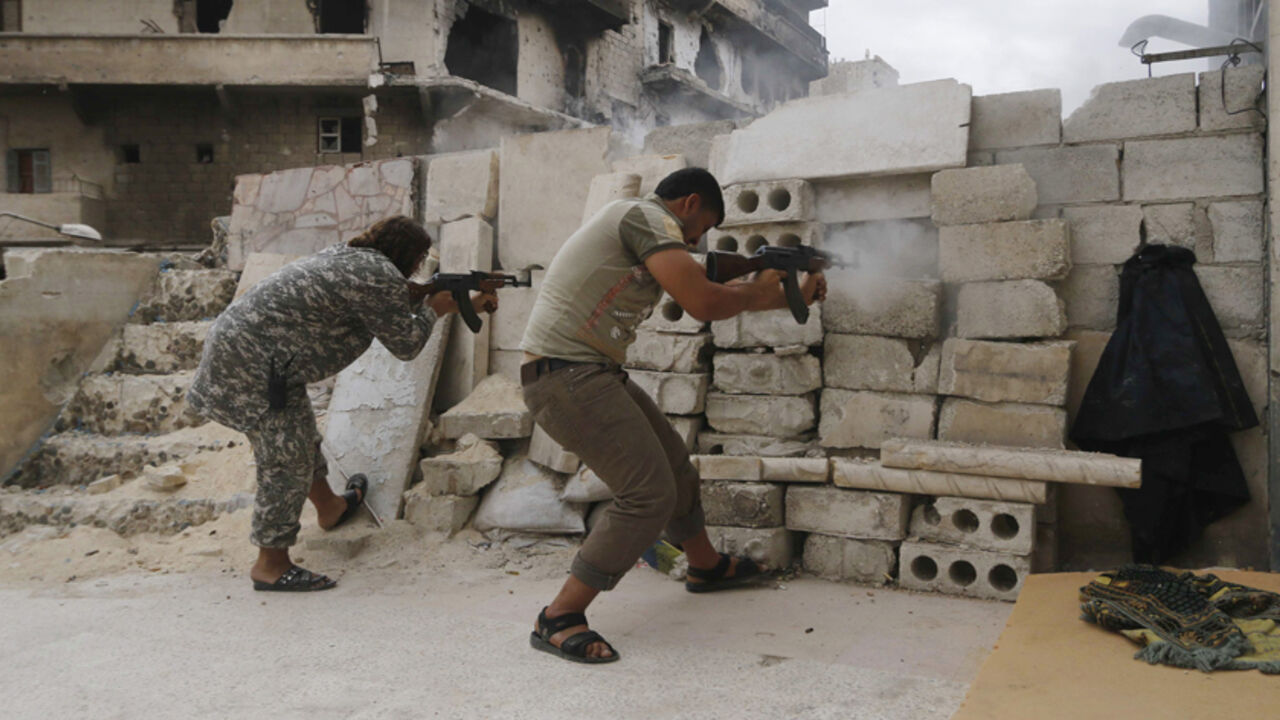 Rebel fighters fire their weapons at the frontline against forces loyal to Syria's President Bashar al-Assad in al-Amriyah Rebel fighters fire their weapons at the frontline against forces loyal to Syria's President Bashar al-Assad in al-Amriyah neighbourhood of Aleppo October 11, 2014. REUTERS/Hosam Katan (SYRIA - Tags: POLITICS CIVIL UNREST MILITARY CONFLICT) - RTR49S8W