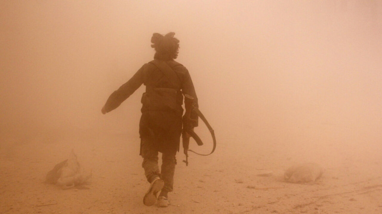 A rebel fighter runs through dust towards an area damaged by what activists said were barrel bombs dropped by warplanes loyal to Syria's President Assad, in Aleppo A rebel fighter runs through dust towards an area damaged by what activists said were barrel bombs dropped by warplanes loyal to Syria's President Bashar al-Assad, in Aleppo's al-Shaar neighborhood November 6, 2014. REUTERS/Rami Zayat (SYRIA - Tags: CIVIL UNREST CONFLICT) - RTR4D5I8