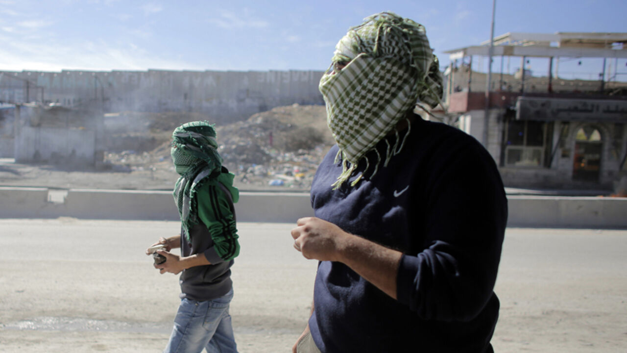 Palestinian protesters take up position during clashes with Israeli troops following a protest against what organizers say are recent visits by Jewish activists to al-Aqsa mosque, at Qalandia checkpoint near Ramallah Palestinian protesters take up position during clashes with Israeli troops following a protest against what organizers say are recent visits by Jewish activists to al-Aqsa mosque, at Qalandia checkpoint near the West Bank city of Ramallah November 7, 2014. In recent months, a campaign for the prayer ban on Jewish worshippers at the site, known to Muslims as the Noble Sanctuary and to Jews as Temple Mount, to be overturned, led by settler activists, has gathered momentum, raising alarm among Palestinians and