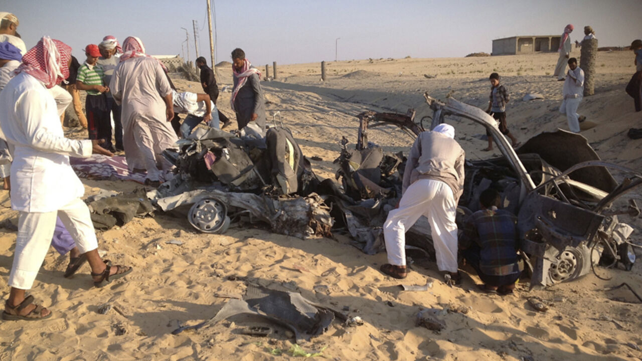 People check the scene where a car bomb exploded in near the port town of El-Arish in Egypt's Sinai peninsula July 24, 2013. A car bomb exploded near a police base and two soldiers were killed in separate, multiple attacks in Egypt's lawless Sinai peninsula, which has seen a spike in violence since the July 3 army ouster of the country's Islamist president. Four militants died when the car, rigged with gas canisters and carrying explosive belts, detonated in a desert area near the port town of El-Arish on W
