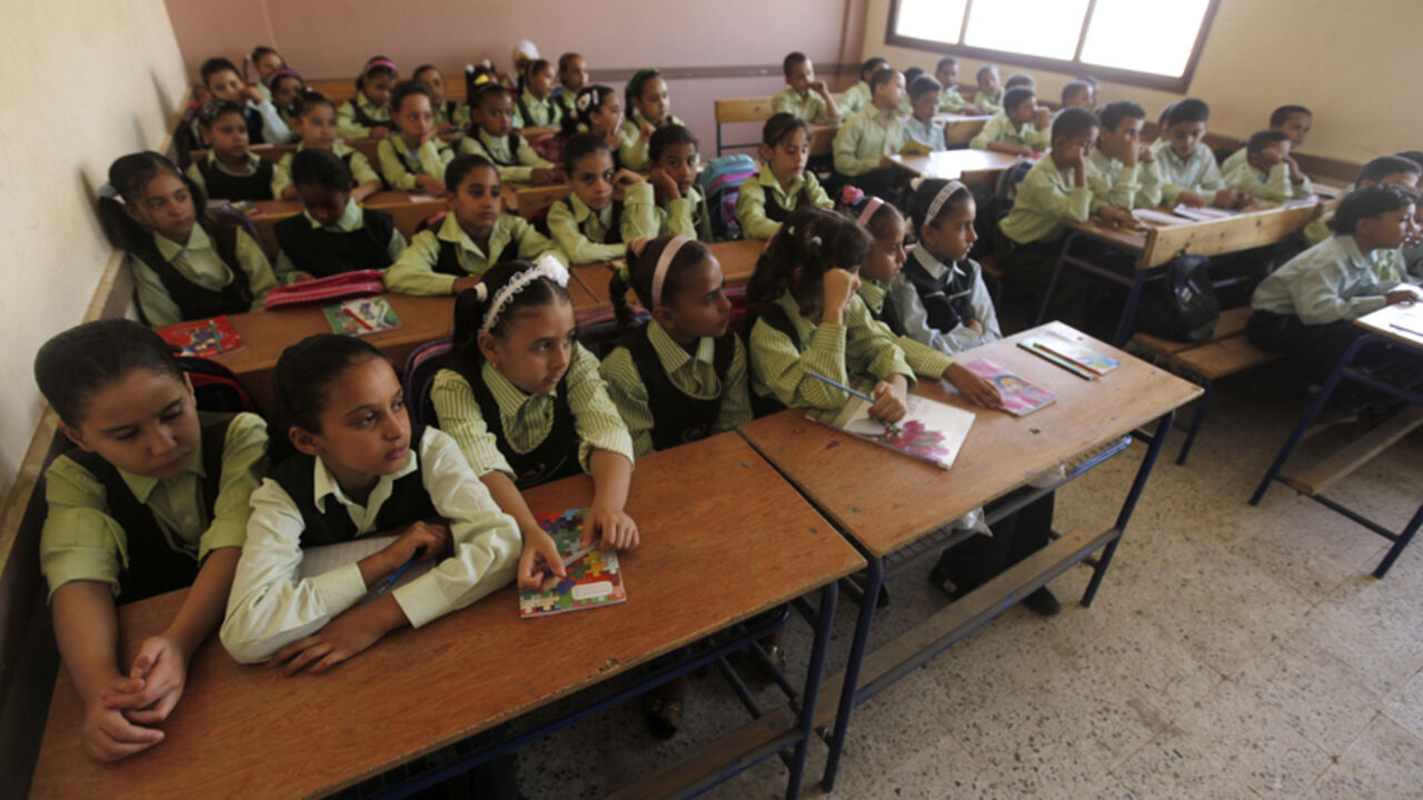 Students attend at a class on the first day of their new school year at a government school in Giza Students attend at a class on the first day of their new school year at a government school in Giza, south of Cairo September 22, 2013. Students resumed their studies at the beginning of the new academic year this weekend amid parental concerns of a possible lack of security after the summer vacation ends. REUTERS/Mohamed Abd El Ghany (EGYPT - Tags: POLITICS EDUCATION) - RTX13UIW