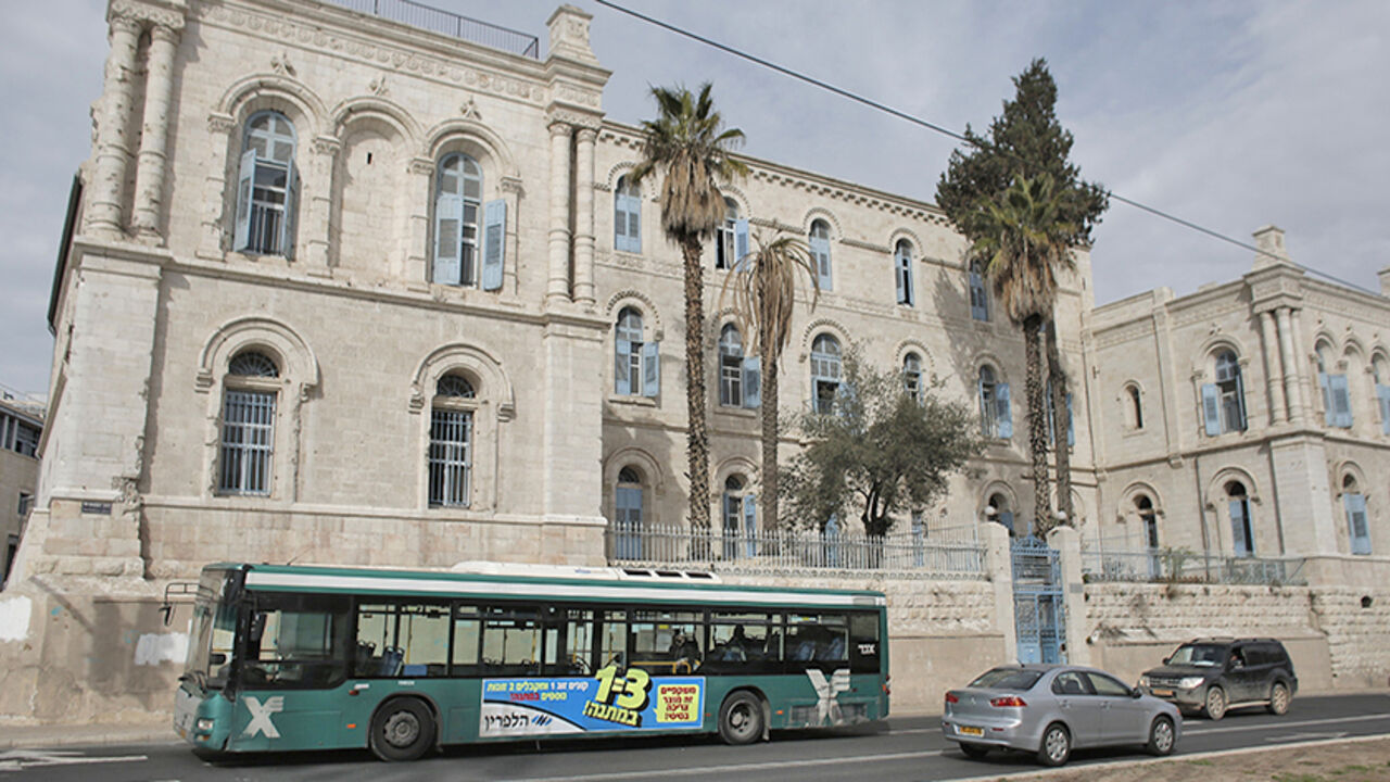Nic6393057 TO GO WITH AFP STORY BY MAJEDA AL-BATSH
A bus owned by Israeli company Egged, the largest bus operating service in Israel passes old buildings in Jerusalem on December 3, 2014. Many Palestinian bus drivers no longer feel safe behind the wheel of Jerusalem's public buses as threats and attacks from Jewish extremists force many to quit their jobs in fear. AFP PHOTO / AHMAD GHARABLI (Photo credit should read AHMAD GHARABLI/AFP/Getty Images)