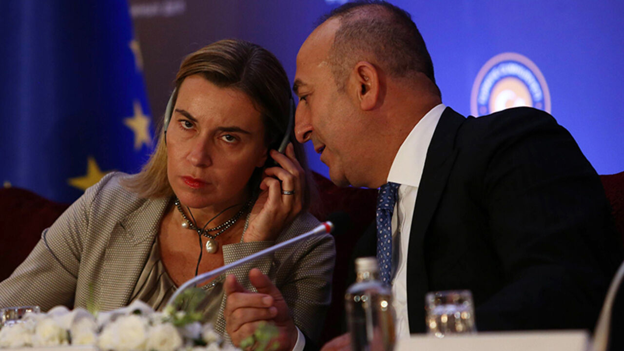 TURKEY-EU-IRAQ-SYRIA-CONFLICT High Representative of the European Union for Foreign Affairs and Security Policy Federica Mogherini (L) and Turkish Foreign Minister Mevlut Cavusoglu (R) speak during a joint press conference after their meeting at the Ankara Palace on December 8, 2014. New European Union foreign policy chief Federica Mogherini was to meet Turkish leaders Monday for talks expected to focus partly on the war against the Islamic State insurgency in neighbouring Syria. AFP PHOTO/ADEM ALTAN (Photo credit should read ADE