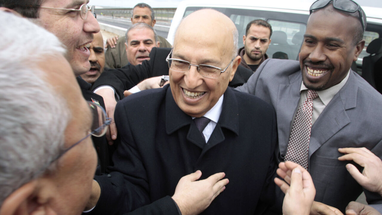 PALESTINIANS/ Senior Fatah leader Nabil Shaath (C) is greeted by Palestinians after crossing into the Gaza Strip at the Erez border crossing February 3, 2010. Shaath arrived in Gaza on Wednesday for a first visit since the Islamist group Hamas seized control of the Gaza Strip from the rival Palestinian President Mahmoud Abbas' Fatah movement in 2007. REUTERS/Ismail Zaydah (GAZA - Tags: POLITICS IMAGES OF THE DAY) - RTR29SK7
