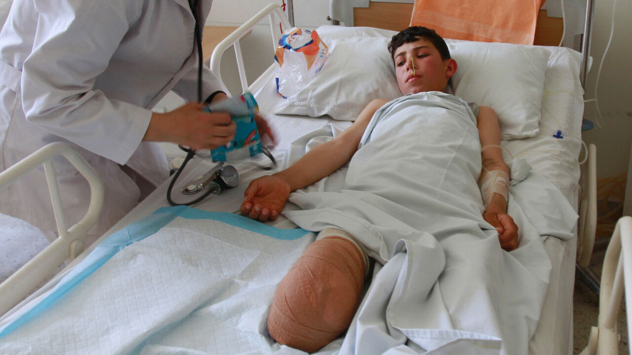 Ahmad Sadek, a 13-year-old Syrian boy, receives medical treatment from a nurse in a government hospital in Tripoli, North Lebanon Ahmad Sadek, a 13-year-old Syrian boy, receives medical treatment from a nurse in a government hospital in Tripoli, North Lebanon June 4, 2012. According to hospital officials, Ahmad was wounded four days ago during shelling by government forces in the town of Qusair in Syria. REUTERS/Omar Ibrahim (LEBANON - Tags: CIVIL UNREST POLITICS) - RTR332UZ