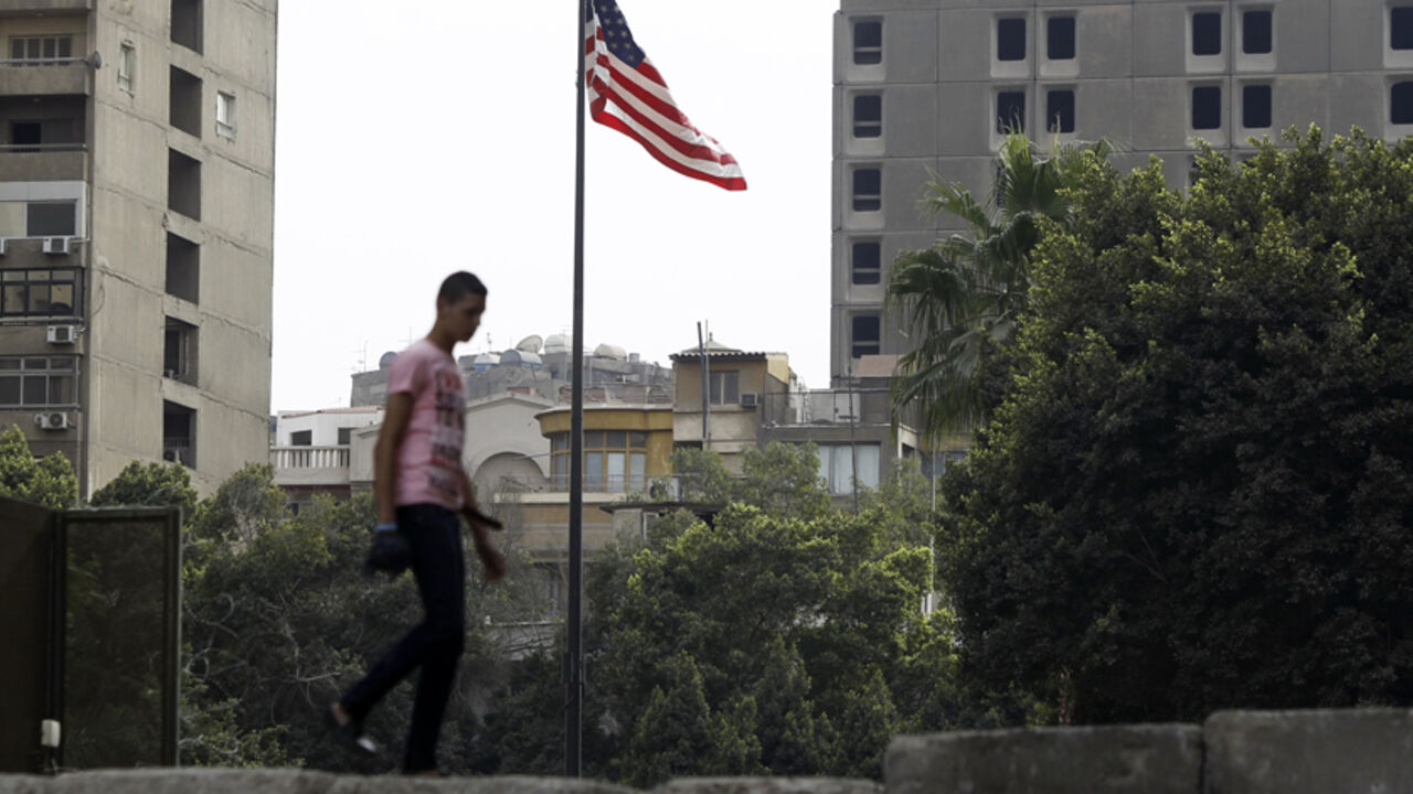 An anti-Mursi protester walks on a wall, that was built by police early on Thursday in order to prevent clashes between protesters and police along a road which leads to the U.S. embassy, near Tahrir Square in Cairo November 29, 2012. The body writing Egypt's new constitution began a session to vote on a final draft on Thursday, a move President Mohamed Mursi's allies in the Muslim Brotherhood hope will help end a crisis prompted by a decree expanding his powers. REUTERS/Amr Abdallah Dalsh  (EGYPT - Tags: P