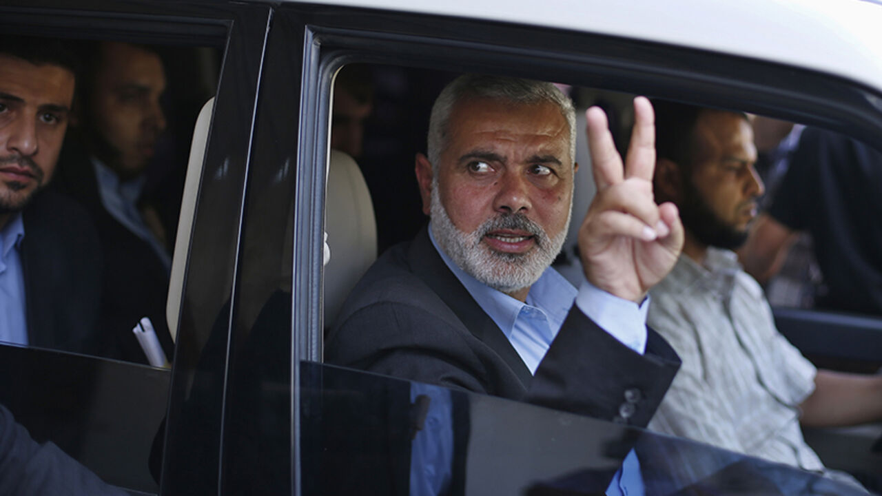 Senior Hamas leader Ismail Haniyeh gestures as leaves his office as a former Hamas government Prime Minister, in Gaza City Senior Hamas leader Ismail Haniyeh gestures as leaves his office as a former Hamas government Prime Minister, in Gaza City June 2, 2014. President Mahmoud Abbas swore in a Palestinian unity government on Monday under a reconciliation deal with Hamas Islamists that led Israel to freeze U.S.-brokered peace talks with the Western-backed leader. REUTERS/Suhaib Salem (GAZA - Tags: POLITICS) - RTR3RTWM