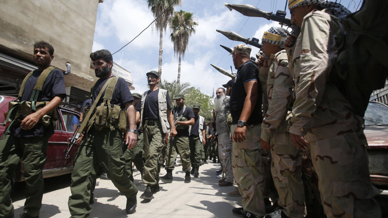 Palestinian gunmen walk during the launch of a joint security force, to maintain stability at the Ain al-Hilweh Palestinian refugee camp near Sidon Palestinian gunmen from different factions walk as they hold their weapons during the launch of a joint security force that includes all Palestinian factions, to maintain stability at the Ain al-Hilweh Palestinian refugee camp near the port-city of Sidon, southern Lebanon July 8, 2014.
REUTERS/Ali Hashisho (LEBANON - Tags: POLITICS MILITARY) - RTR3XMT6