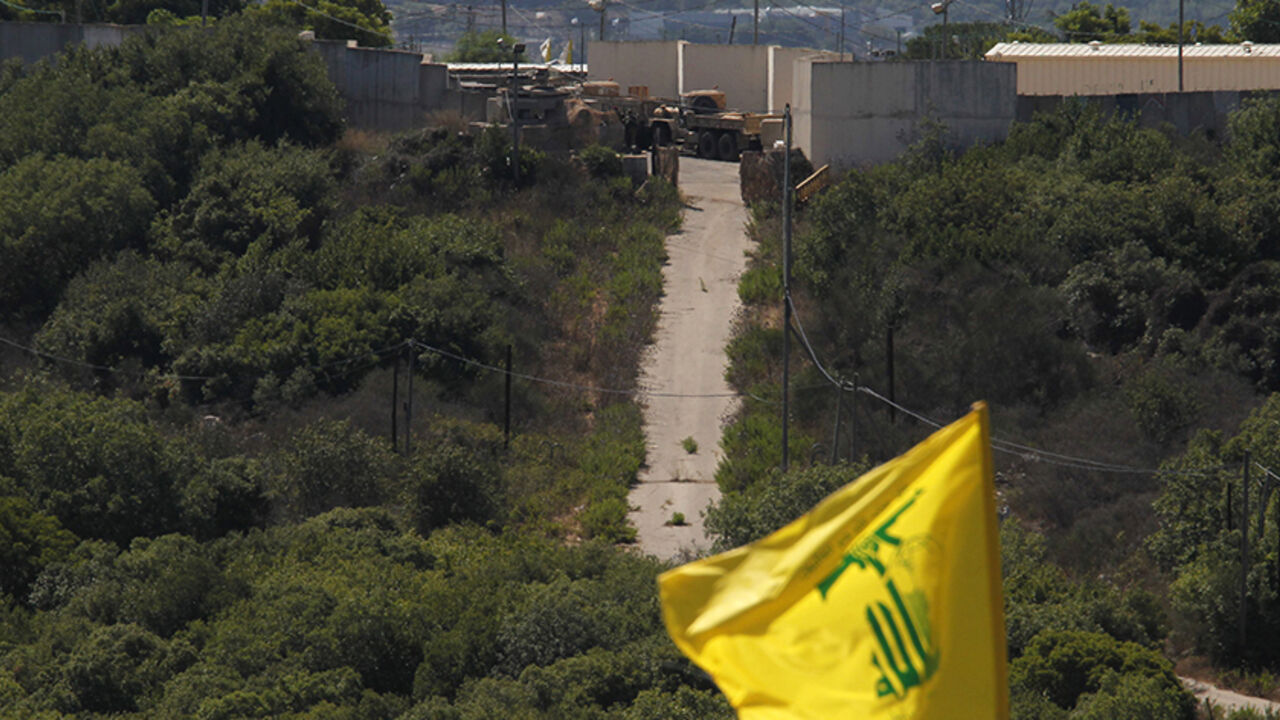 Israeli soldiers and trucks are seen from the southern Lebanese village Marwaheen, as a Hezbollah flag flutters during a protest in solidarity with Palestinian people in Gaza near the Lebanese-Israeli border Israeli soldiers and trucks are seen from the southern Lebanese village Marwaheen, as a Hezbollah flag flutters during a protest in solidarity with Palestinian people in Gaza near the Lebanese-Israeli border July 25, 2014. The protest was organised by Hezbollah with the participation of Shi'ite and Sunni Muslim Sheikhs, against Israel's military action in Gaza and marking the annual al-Quds Day. REUTERS/Ali Hashisho (LEBANON - Tags: POLITICS CIVIL UNREST RELIGION MILITARY) - RTR403PX
