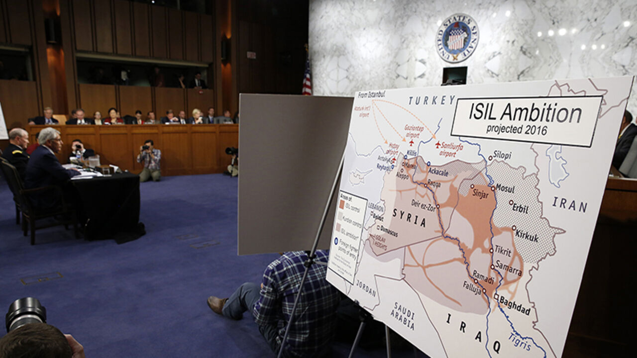 IRAQ-CRISIS/USA A map showing Islamic State ambition is displayed as U.S. Secretary of Defense Chuck Hagel (L) and Chairman of the Joint Chiefs of Staff Gen. Martin Dempsey testify during the Senate Armed Services Committee hearing on U.S. policy toward Iraq and Syria and the threat posed by the Islamic State on Capitol Hill in Washington September 16, 2014. REUTERS/Kevin Lamarque (UNITED STATES - Tags: POLITICS MILITARY) - RTR46GAJ