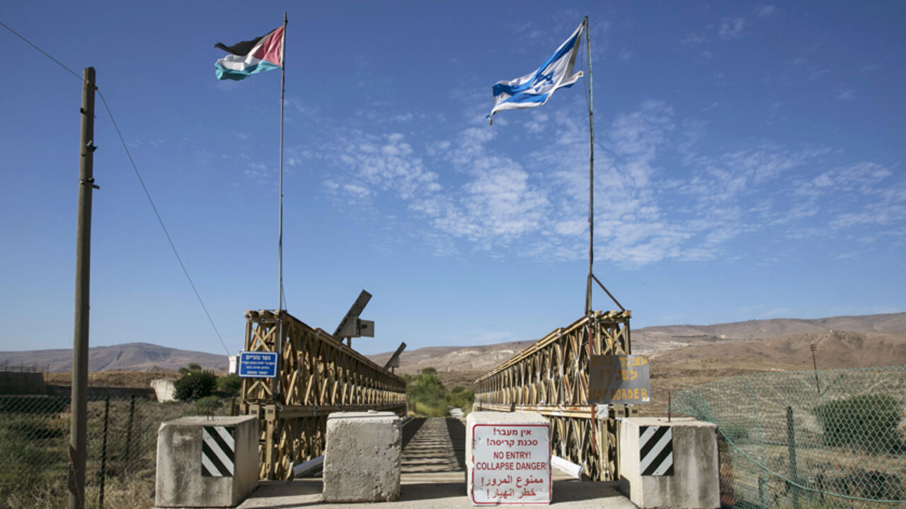 MIDEAST-ISRAEL/JORDAN National Jordanian and Israeli flags are seen on the Naharayim bridge on the border between Israel and Jordan north-eastern Israel October 22, 2014. With attacks by Hezbollah from Lebanon, the threat from Islamic State and the Nusra Front in Syria and growing unrest in Egypt's Sinai, the north and south of Israel?s borders are on edge. By comparison, the eastern frontier with Jordan looks like an oasis of calm. Yet the Hashemite kingdom, wedged between Iraq, Syria and Saudi Arabia as well as Israel and the