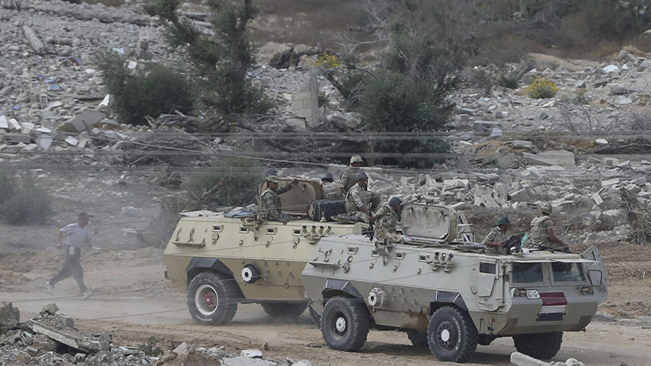 Egyptian soldiers keep guard during a military operation in the Egyptian city of Rafah, near the border with the southern Gaza Strip October 30, 2014. Egypt began clearing residents from its border with the Gaza Strip on Wednesday to create a buffer zone following some of the worst anti-state violence since President Mohamed Mursi was overthrown last year. A day after being ordered by the army to move, many in the area had already packed their belongings and begun to leave when an announcement from Cairo ma