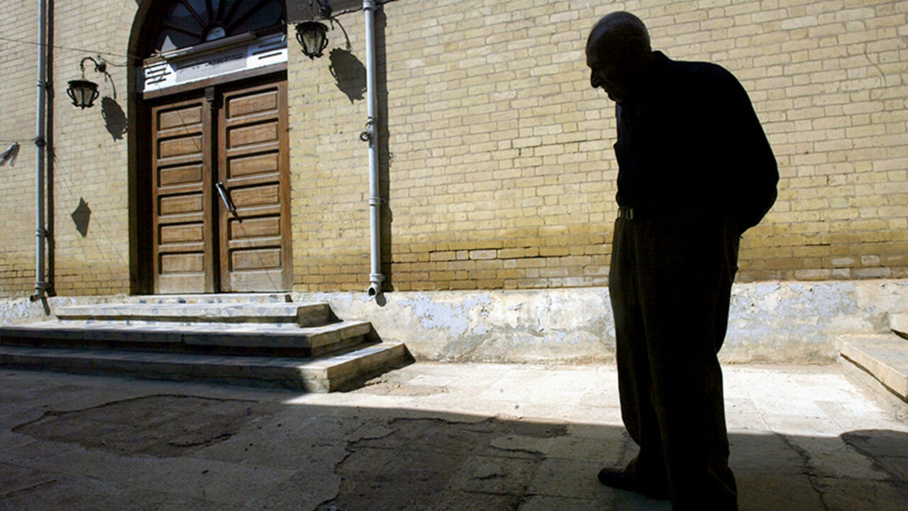 1936329MT007_passover BAGHDAD, IRAQ - APRIL 17: Iraqi Jew Yusef Salman, 79, stands in front of the synagogue in the tiny remaining Baghdad Jewish community on Passover April 17, 2003 in Baghdad, Iraq. Salman's brothers left Iraq in 1948 and he has not seen them since. He has no remaining family in Iraq. The community members are not formally celebrating the holiday this year due to a lack of electricity, food and other problems associated with the war. The family has lived their entire life in Baghdad while the Jewish community
