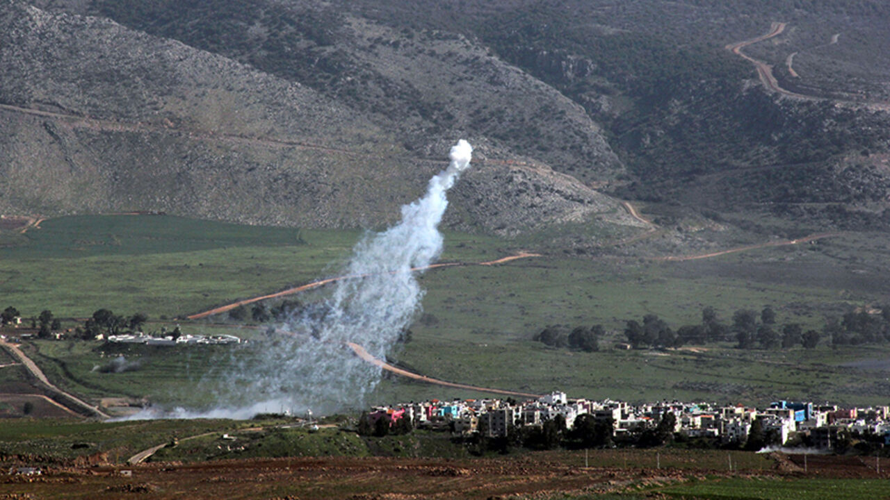 Nic6411672 Smoke from Israeli shelling covers the Lebanese town of Al-Majidiyah (L) on the Lebanese border with Israel as the town of Al-Ghajar is seen on the right on January 28, 2015. Lebanese Shiite militant group Hezbollah claimed responsibility on Wednesday for an attack against a military convoy in an Israeli-occupied border area. AFP PHOTO / ALI DIA (Photo credit should read ALI DIA/AFP/Getty Images)