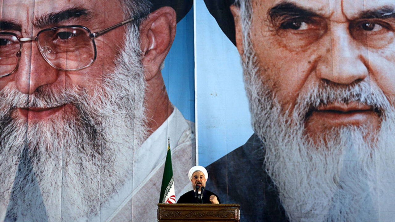 Par7897284 Iranian President Hassan Rouhani delivers a speech under portraits of Iran's supreme leader, Ayatollah Ali Khamenei (L) and Iran's founder of the Islamic Republic, Ayatollah Ruhollah Khomeini (R), on the eve of the 25th anniversary of the Islamic revolutionary leader Ayatollah Ruhollah Khomeini's death, at his mausoleum in a suburb of Tehran on June 3, 2014. AFP PHOTO / ATTA KENARE (Photo credit should read ATTA KENARE/AFP/Getty Images)