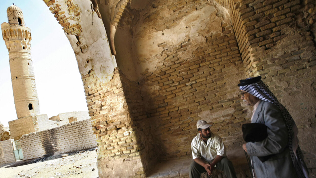 Nic356928 TO GO WITH STORY BY JOSEPH KRAUSS An Iraqi man leaves an indoor market as he walks towards the 14th-century brick minaret of the Dhu al-Kifl mosque at the site of the Jewish shrine of Ezekiel -- the prophet who followed the Judeans into the Babylonian exile in the 6th century BC -- in the Iraqi town of Kifl, south of Baghdad. Muslims revere nearly all the central religious figures from Judaism and Christianity, including Ezekiel, referred to as Dhu al-Kifl in two Koranic verses and said to have raised the