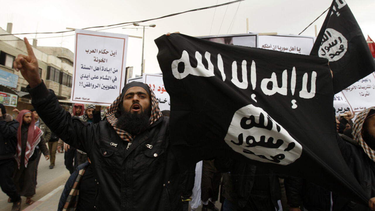 Palestinian Salafists take part in a protest against Syria's President Bashar al-Assad in Rafah in the southern Gaza Strip February 24, 2012. The black flag reads "There is no god but Allah and Mohammad is the prophet". The white sign reads "Where are the traitor Arab rulers". REUTERS/Ibraheem Abu Mustafa (GAZA - Tags: POLITICS CIVIL UNREST) - RTR2YDGR
