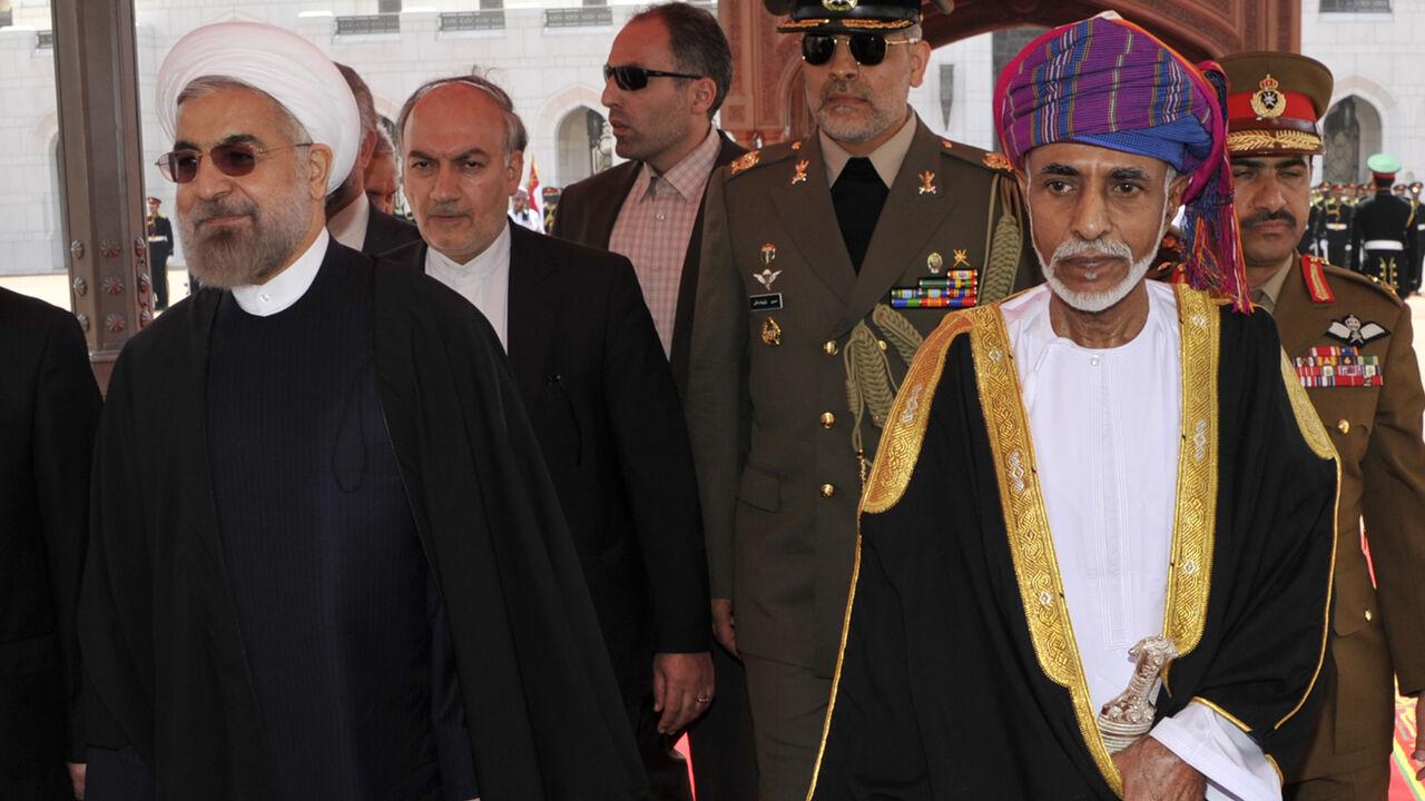 OMAN/ Oman's Sultan Qaboos bin Said (R) walks with Iran's President Hassan Rouhani upon Rouhani's arrival in Muscat March 12, 2014. REUTERS/Sultan Al Hasani (OMAN - Tags: POLITICS ROYALS) - RTR3GQAH