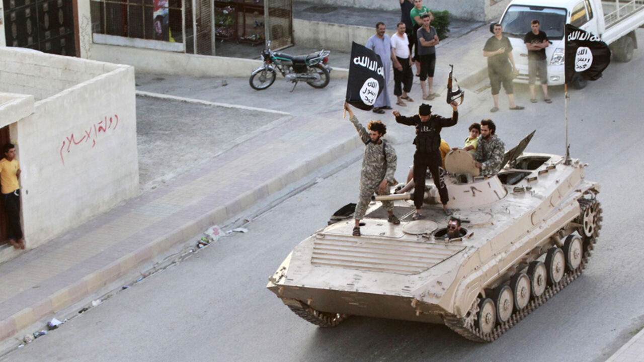 SYRIA-CRISIS/IRAQ Militant Islamist fighters take part in a military parade along the streets of northern Raqqa province June 30, 2014. Militant Islamist fighters held a parade in Syria's northern Raqqa province to celebrate their declaration of an Islamic "caliphate" after the group captured territory in neighbouring Iraq, a monitoring service said. The Islamic State, an al Qaeda offshoot previously known as Islamic State in Iraq and the Levant (ISIL), posted pictures online on Sunday of people waving black flags from cars