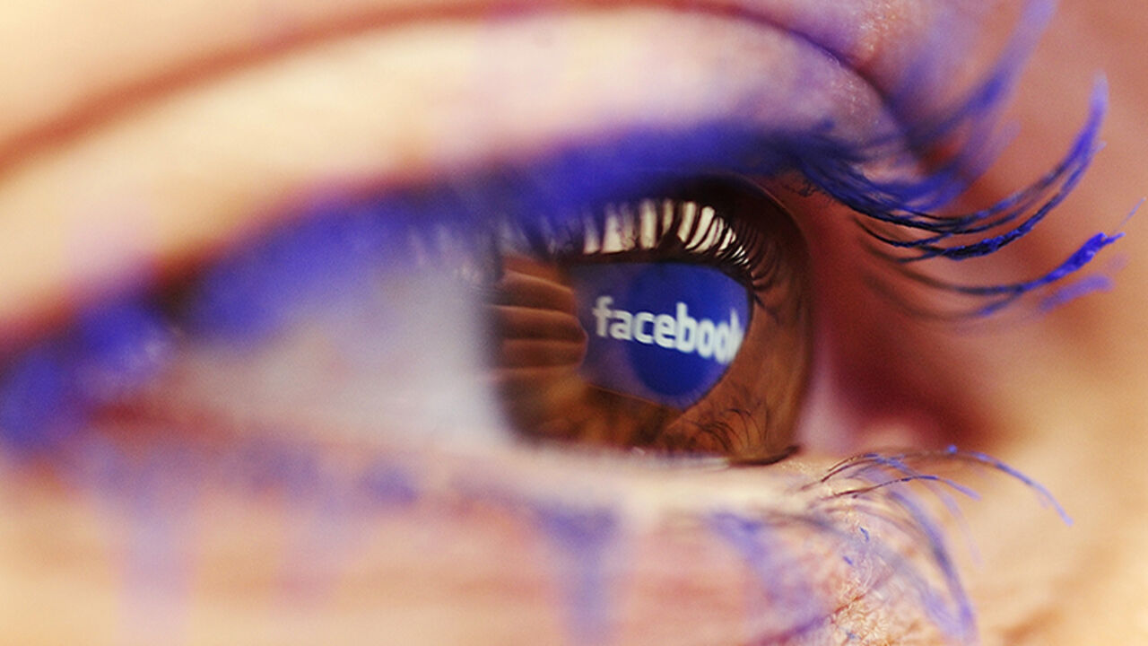 MACEDONIA-BUSINESS/ A Facebook logo reflected in the eye of a woman is seen in this picture illustration taken in Skopje November 6, 2014. Picture take November6. REUTERS/Ognen Teofilovski (MACEDONIA - Tags: BUSINESS LOGO) - RTR4DKUK