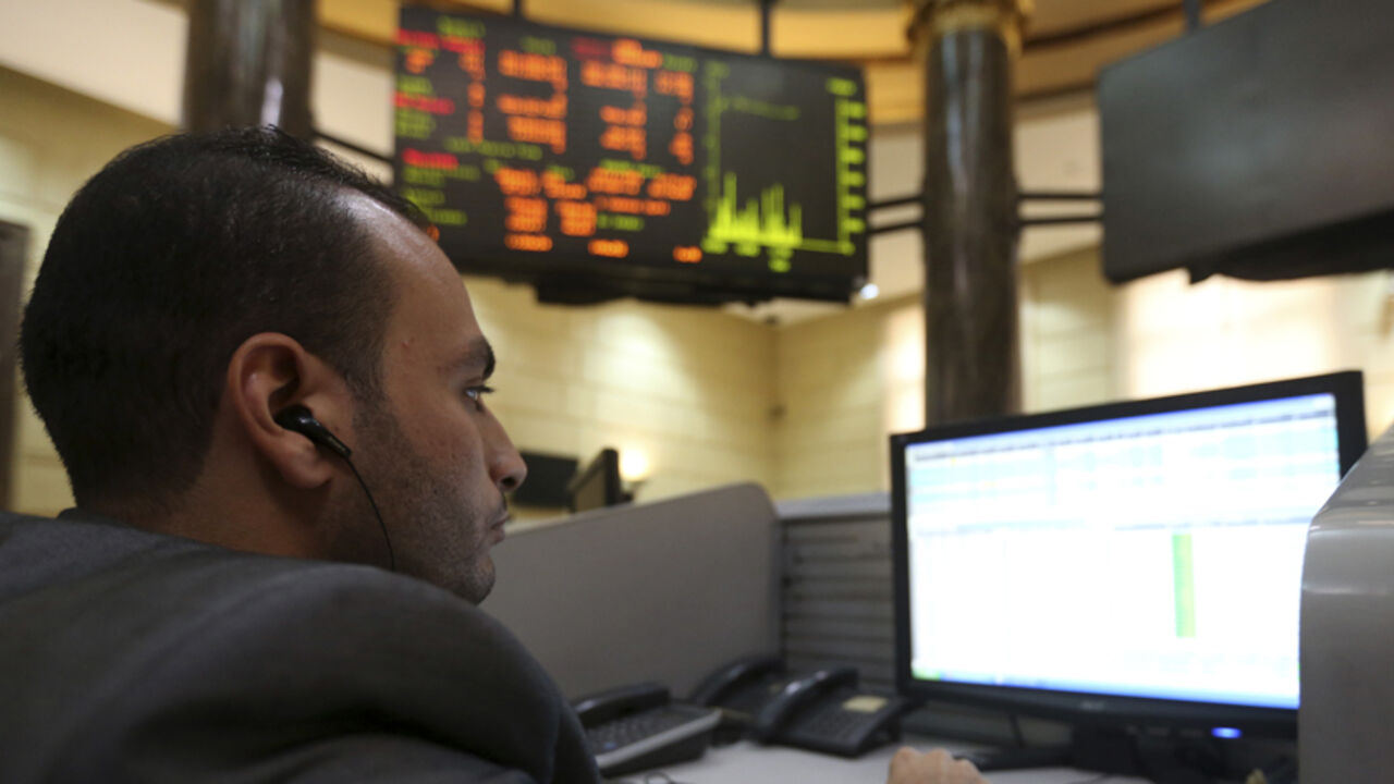 EGYPT-FOREX A trader works at the Egyptian stock exchange in Cairo, November 19, 2014. The Egyptian pound was flat at a central bank dollar sale on Wednesday but weakened significantly on the black market as Egypt's plans to repay a $2.5 billion Qatari deposit raised concerns of a looming dollar shortage, traders said. REUTERS/Mohamed Abd El Ghany (EGYPT - Tags: BUSINESS) - RTR4EQ3Y