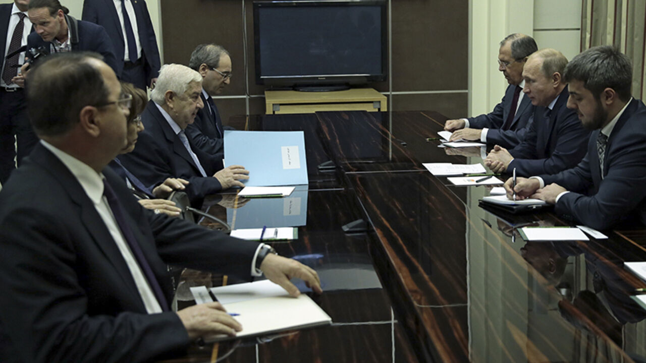 Syria's Foreign Minister Walid al-Moualem (3rd L) speaks to Russia's President Vladimir Putin (2nd R) and Foreign Minister Sergei Lavrov (3rd R) during a meeting at the Bocharov Ruchei state residence in Sochi, November 26, 2014. Putin met al-Moualem in Russia's Black Sea resort of Sochi for talks on Wednesday, the Kremlin said. Moualem's two-day visit to Russia, a key ally of President Bashar al-Assad in the Syrian conflict, appears to be the latest move in a renewed diplomatic effort by Moscow to restart 