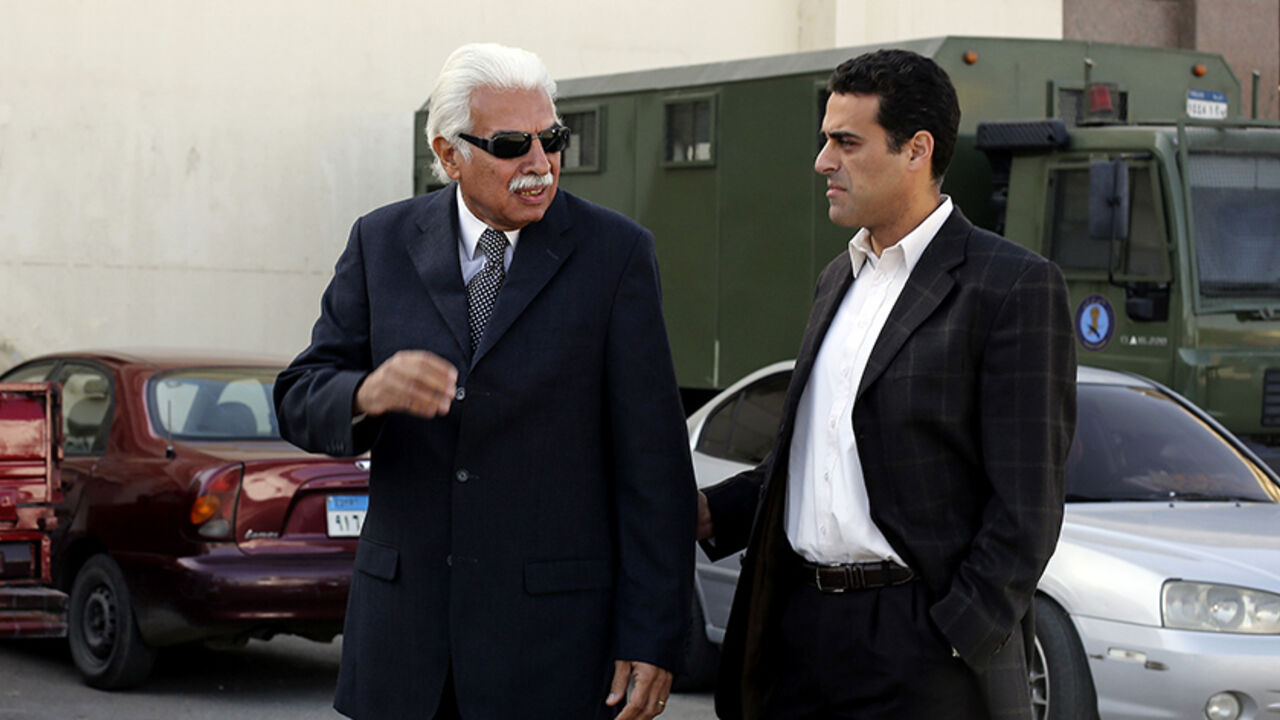 EGYPT-POLITICS/ Former Egyptian Prime Minister Ahmed Nazif (L) walks with his son outside of a court after his trial was delayed, in the outskirts of Cairo, December 29, 2014. Nazif is facing a retrial as he was convicted of a corruption case for which he had been held since the revolution that toppled Hosni Mubarak. REUTERS/Asmaa Waguih (EGYPT - Tags: POLITICS CRIME LAW) - RTR4JJQM