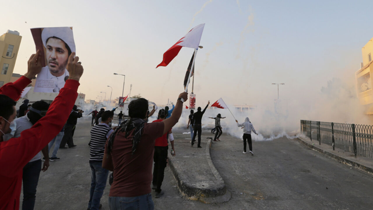 BAHRAIN-COURTS/ Protesters holding a Bahraini flags and a photo of the leader of Bahrain's main opposition party Al Wefaq, Ali Salman, shout anti-government slogans during clashes in the village of Bilad Al Qadeem south of Manama, January 6, 2015.
Bahraini police fired rubber bullets and tear gas to scatter protesters who gathered outside the home of Sheikh Ali Salman, a Shi'ite Muslim opposition leader on Monday, witnesses said, after he was remanded in custody for a further 15 days. Around 100 protesters angry at the d