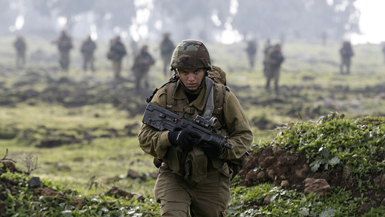 MIDEAST-CRISIS/ISRAEL-SYRIA An Israeli soldier from the Golani brigade takes part in training near the city of Katzrin in the Golan Heights January 19, 2015. An Israeli helicopter strike in Syria killed a commander from Lebanon's Hezbollah and the son of the group's late military leader Imad Moughniyah, Hezbollah said, in a major blow that could lead to reprisal attacks.The strike hit a convoy carrying Jihad Moughniyah and commander Mohamad Issa, known as Abu Issa, in the province of Quneitra, near the Israeli-occupied Golan Heights,