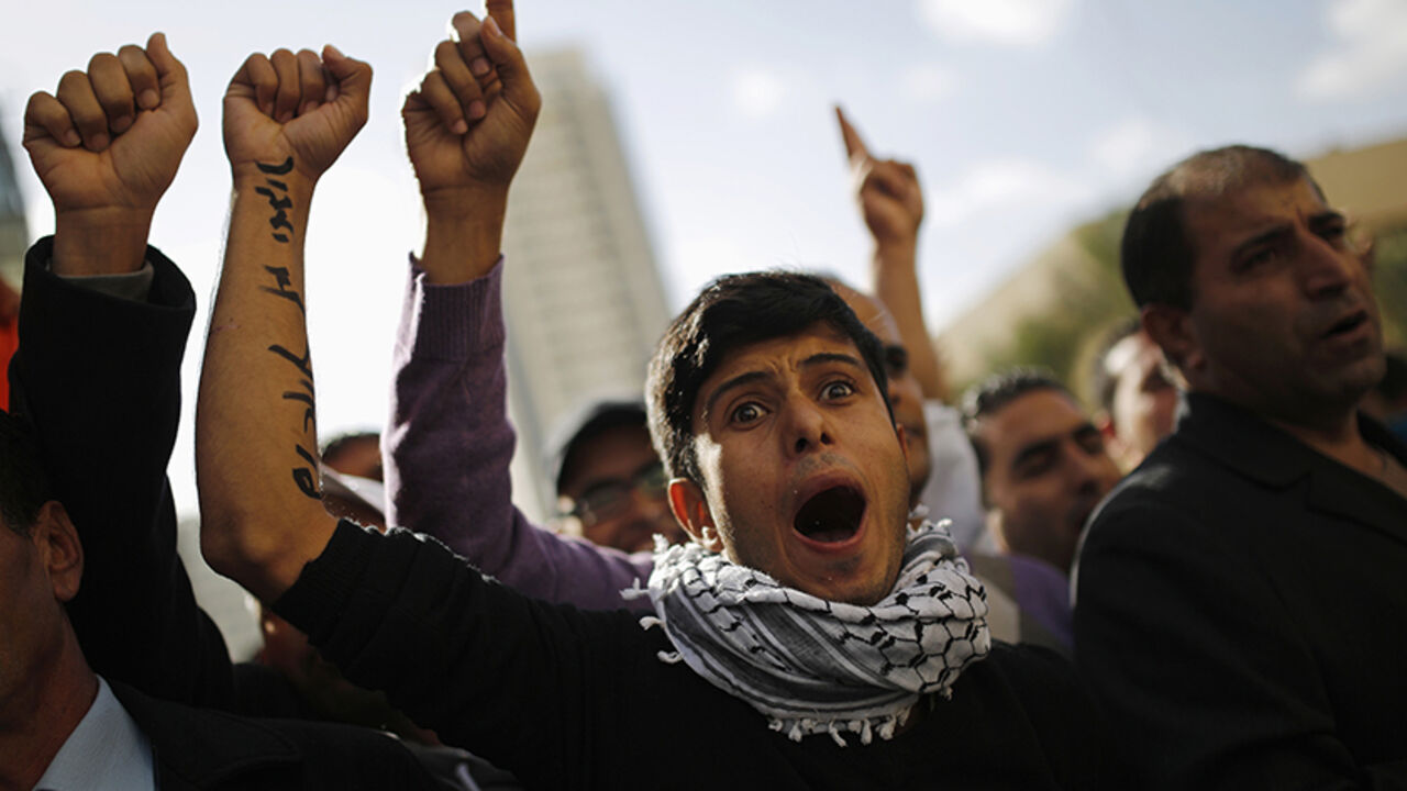 ISRAEL-BEDOUIN/ Members of the Bedouin community gesture during a protest outside a court in the southern city of Beersheba, calling to release people who were arrested last Saturday in protests against a government plan to force 40,000 Bedouins living in the southern Negev region to leave their villages, December 5, 2013. Hundreds of Bedouin Arabs and their supporters clashed with Israeli forces on Saturday in the protests, in which, according to an Israeli police spokesman, at least 28 people had been arrested. REUTERS/A