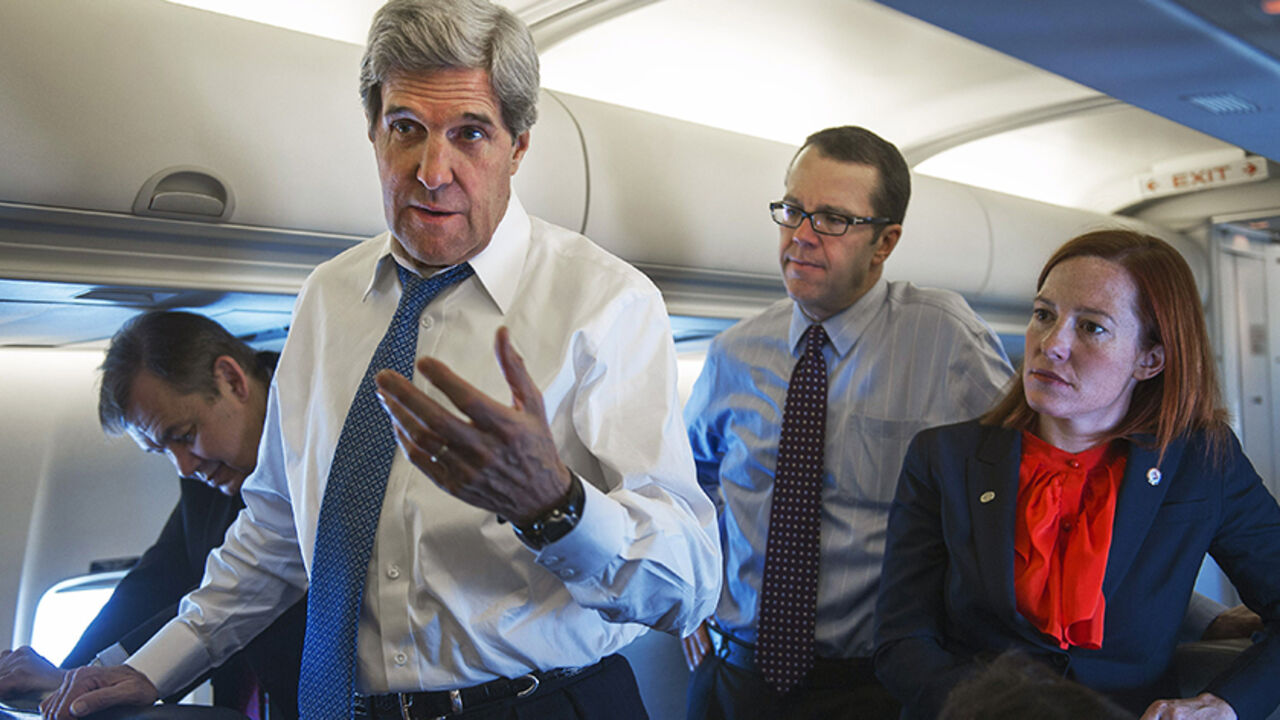 KOREA-NORTH U.S. Secretary of State John Kerry (front) talks with reporters aboard his government aircraft shortly after departing Seoul Air Base April 13, 2013, for Beijing, China. To rear of Kerry are Senior Staff members Glen Johnson (2nd R) and Jen Psaki (R) REUETRS/Paul J. Richards/Pool (SOUTH KOREA - Tags: POLITICS) - RTXYJO9