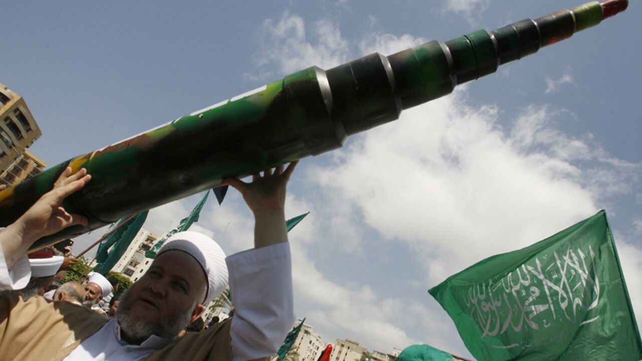Nic6347868 A man holds a mock Qassam rocket during a rally organised by Lebanese and Palestinian supporters of the Islamist movement Hamas and the Islamic Group, Jamaa Islamiya in solidarity with Palestinians in the Gaza strip where Hamas is engaged in a major confrontation with the Israeli army on July 11, 2014 in the southern Lebanese city of Sidon. Two Palestinians were killed in an Israeli strike, raising the toll in four days of violence to 100, Gaza health ministry spokesman Ashraf al-Qudra said. AFP PHOTO / MAH