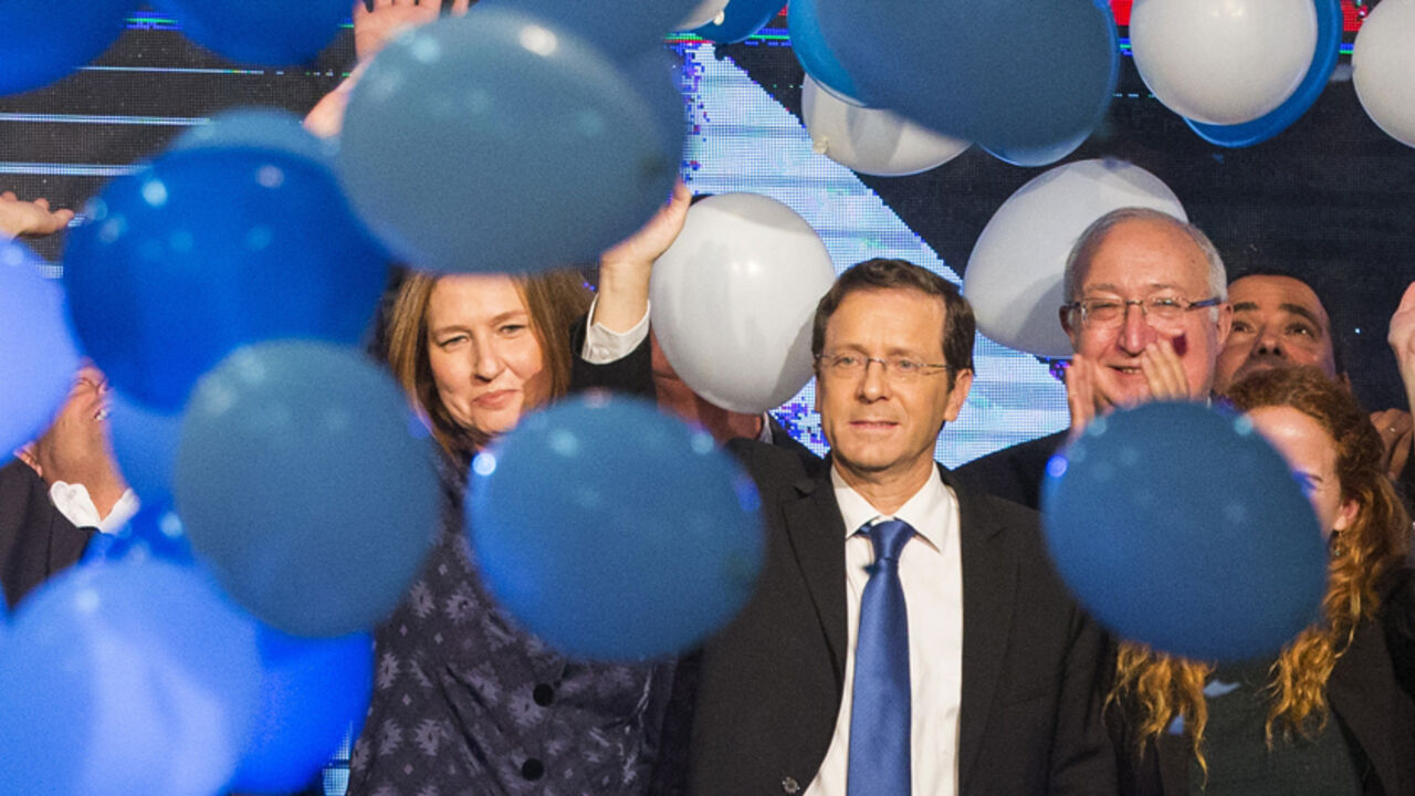 Nic6410966 Israeli Labour Party leader Isaac Herzog (C-R) and former justice minister and Hatnuah party leader Tzipi Livni (L) wave during an election campaign meeting in Tel Aviv, on January 25, 2015 ahead of the March 17 general elections. Opposition Labour party head Isaac Herzog and Livni have made an alliance to contest Israel's snap general election. Most Israelis would like to see Prime Minister Benjamin Netanyahu replaced after March elections but, paradoxically, he is seen as most suitable for the job, an opi