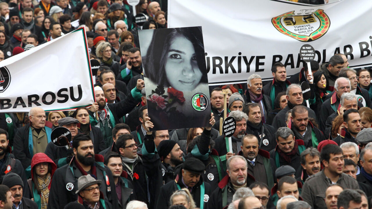Par8099918 A Member of Turkey's Bar Associations holds a poster depicting slain Ozgecan Aslan, in Ankara, on February 16, 2015 during a march to protest against a law that strenghtens the police's power. Anger mounted in Turkey Monday over the murder and attempted rape by a bus driver of the 20-year-old female student whose burned body was discovered on February 13, as a court placed three suspects in pre-trial detention over the brutal killing. AFP PHOTO/ADEM ALTAN (Photo credit should read ADEM ALTAN/AFP/Gett