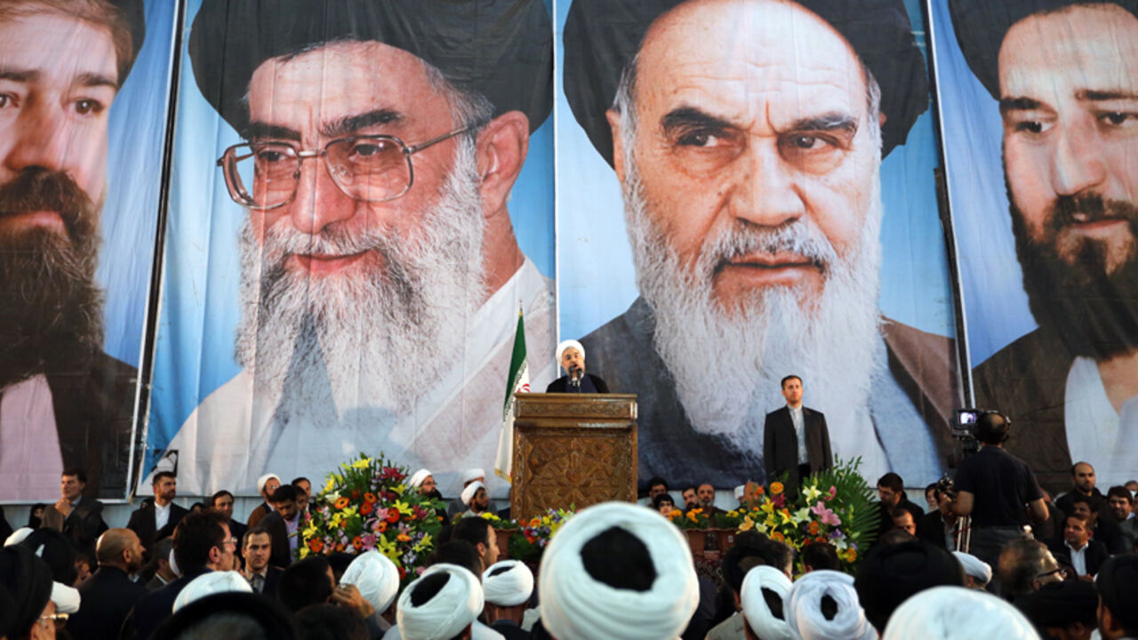 Par7897288 Iranian President Hassan Rouhani delivers a speech under portraits of Iran's supreme leader, Ayatollah Ali Khamenei (Center L) and Iran's founder of the Islamic Republic, Ayatollah Ruhollah Khomeini (Center R), on the eve of the 25th anniversary of the Islamic revolutionary leader Ayatollah Ruhollah Khomeini's death, at his mausoleum in a suburb of Tehran on June 3, 2014. AFP PHOTO / ATTA KENARE (Photo credit should read ATTA KENARE/AFP/Getty Images)