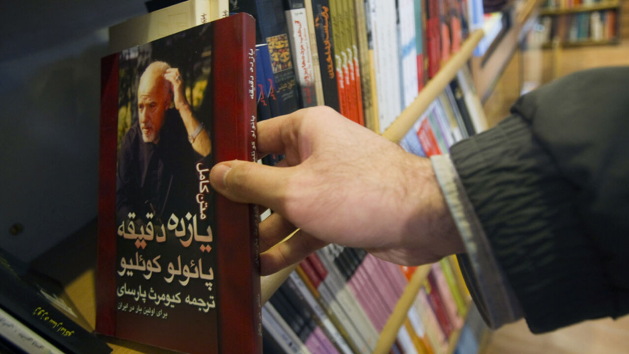 IRAN-BOOKS/ EDITORS' NOTE: Reuters and other foreign media are subject to Iranian restrictions on leaving the office to report, film or take pictures in Tehran.
A customer holds a copy of the translated novel "Eleven Minutes" written by the Brazilian novelist Paulo Coelho at a bookshop in central Tehran January 29, 2011. Iranians are feeling the pinch from radical cuts in state subsidies, a plan President Mahmoud Ahmadinejad has called "the biggest economic plan in the past 50 years". The cuts in long-standing subsidi