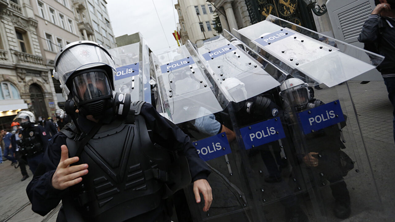 TURKEY-ERDOGAN/ Turkish riot police use their shields to protect themselves as they clash with demonstrators during a protest in central Istanbul May 31, 2014. On the first anniversary of nationwide protests that shook Prime Minster Tayyip Erdogan's rule, barely a thousand anti-government demonstrators marched in Istanbul on Saturday. Outnumbered by riot police, they were soon sent scurrying into side streets by tear gas and water cannon. Their scant numbers were an illustration of Erdogan's tightening grip on power despit
