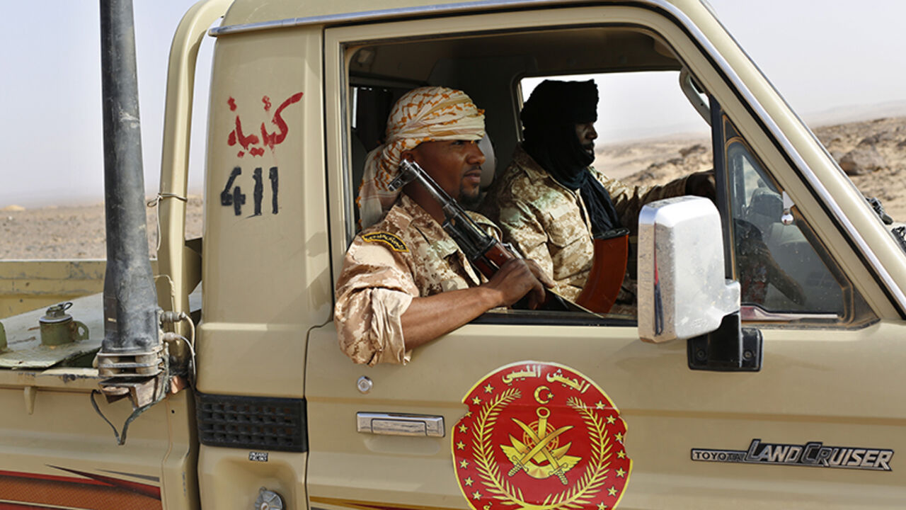 LIBYA-SECURITY/ A Libyan army vehicle patrols on a desert road between Libya and Algeria May 29, 2014. Libya's southwestern tip in the Sahara bordering Algeria and Niger has turned into an open door for illegal migrants from sub-Saharan countries heading for Europe, with the chaotic government in Tripoli appearing to have abandoned all control. The revolt that overthrew Libyan leader Muammar Gaddafi three years ago emptied Libya's arsenals, flooded the region with guns and dismantled much of the state apparatus, giving wel