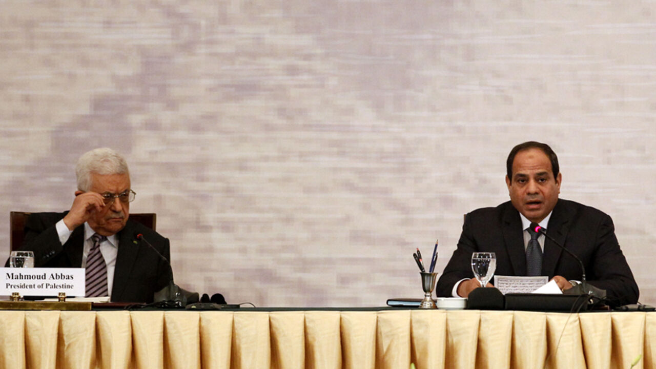 GAZA-EGYPT/CONFERENCE Palestinian President Mahmoud Abbas (L) and Egyptian President Abdel Fattah al-Sisi attend a Gaza reconstruction conference in Cairo October 12, 2014. Egypt, which brokered a ceasefire between Israel and the Palestinians in Gaza after a 50-day war, used a reconstruction conference in Cairo on Sunday to call for a wider peace deal based on a 2002 Arab initiative. REUTERS/Mohamed Abd El Ghany (EGYPT - Tags: POLITICS) - RTR49UU5