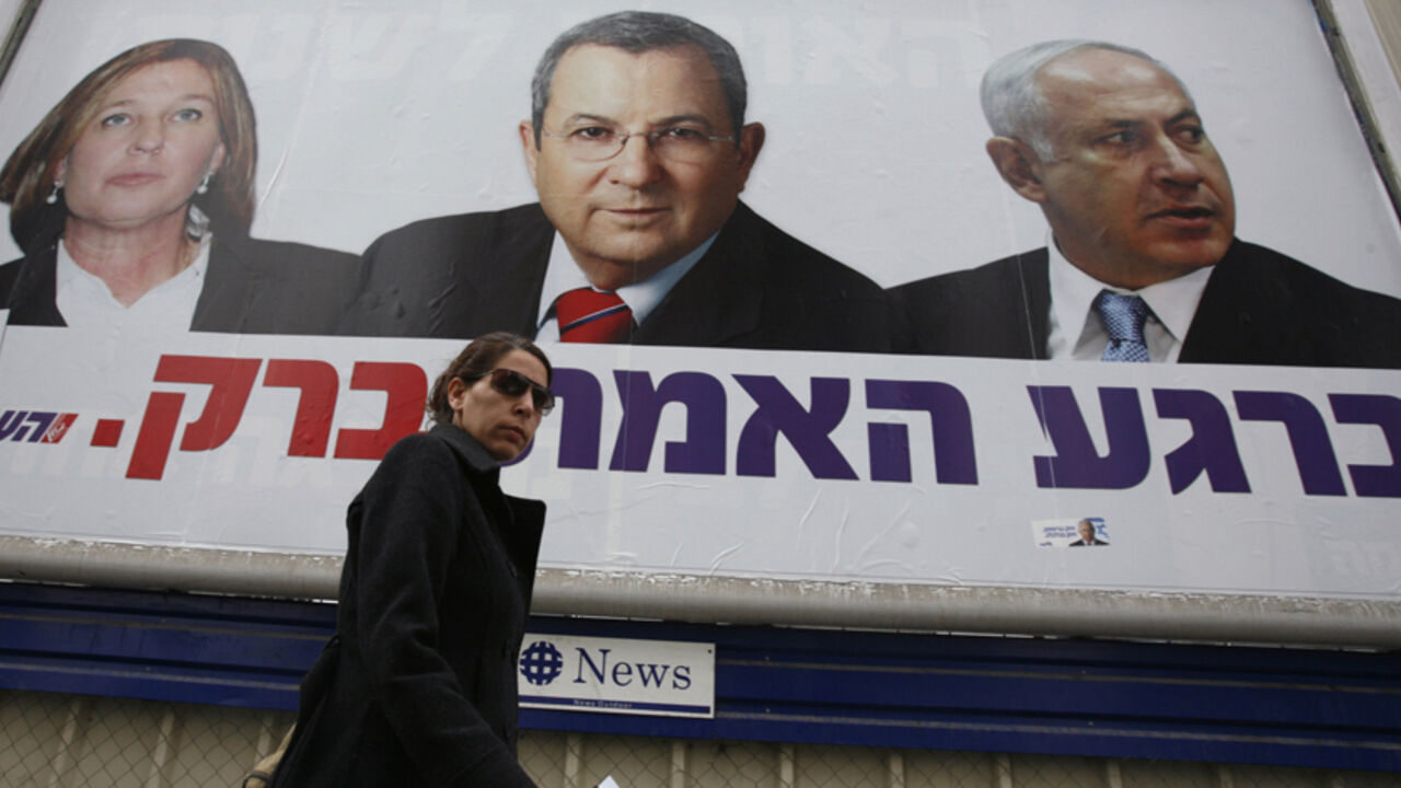 ISRAEL-ELECTION/ A pedestrian walks under a Labour party campaign billboard depicting party leader and Defence Minister Ehud Barak (C), Likud party leader Benjamin Netanyahu (R) and Foreign Minister Tzipi Livni in Ramat Gan near Tel Aviv February 8, 2009. Surveys predict a narrow win in Tuesday's vote for hawkish ex-premier Netanyahu, his comeback fuelled by the inconclusive wars in southern Lebanon and Gaza, formerly areas under Israel's control and now bastions of hostile Islamists. REUTERS/Gil Cohen Magen (ISRAEL) - RTXB